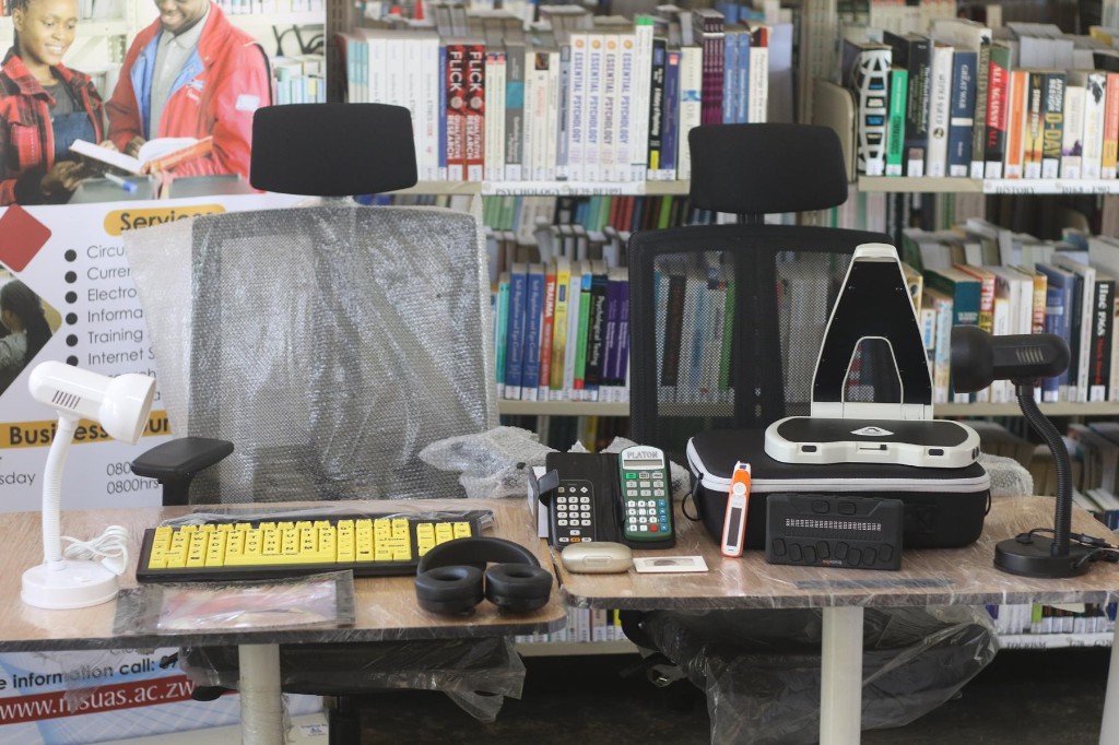 Hark Reader, Braille One Reader, calculator and other assistive devices on library desks