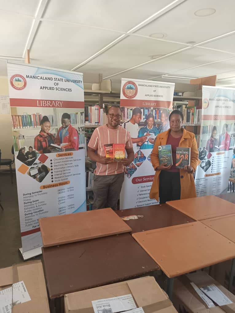 MSUAS Library staff displaying curated novels for school donation